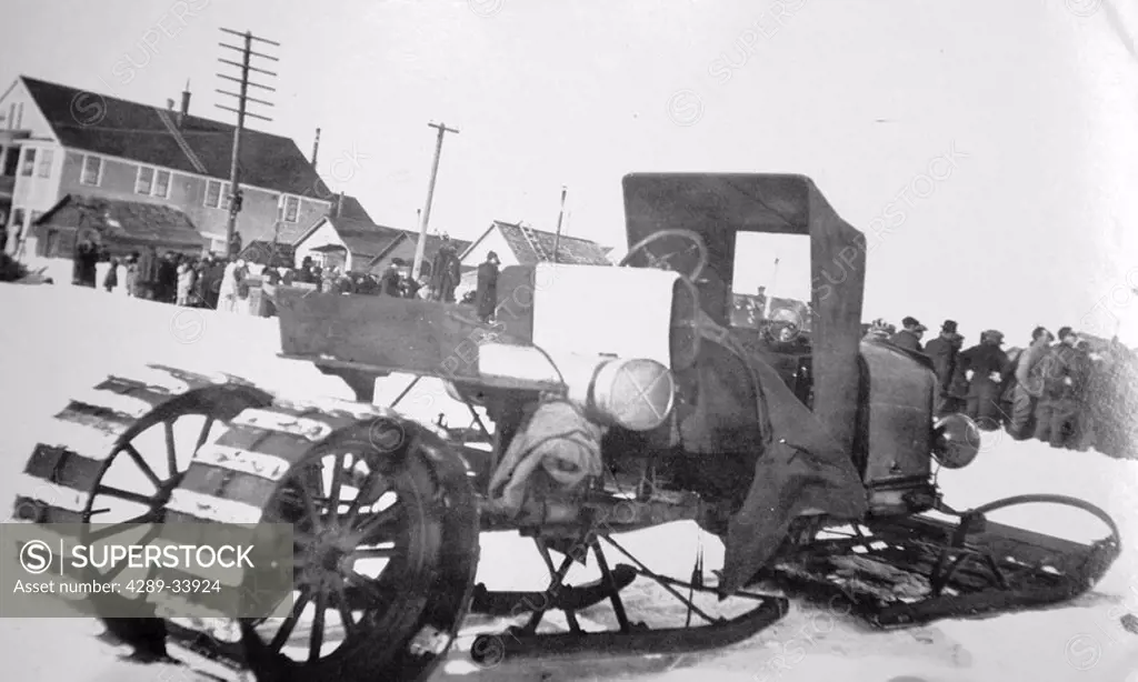 Historical image of a early example of a vehicle modified for winter use in snow winter Nome WE Alaska