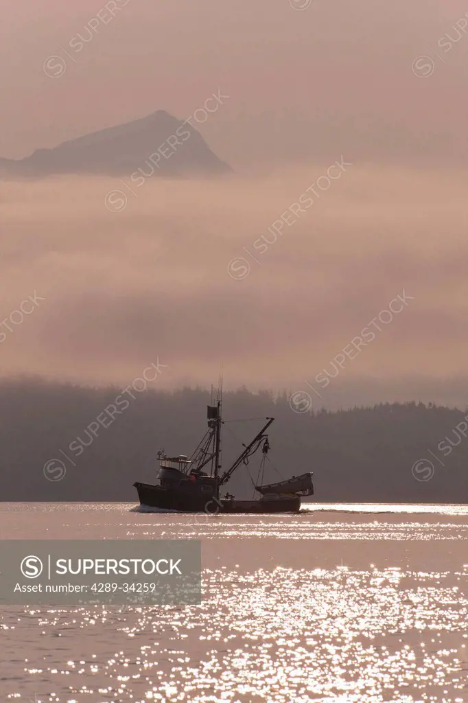 A commercial fishing seiner travels to a pink salmon opening on a misty morning in Fredrick Sound and Stephens Passage, Inside Passage, Tongass Nation...