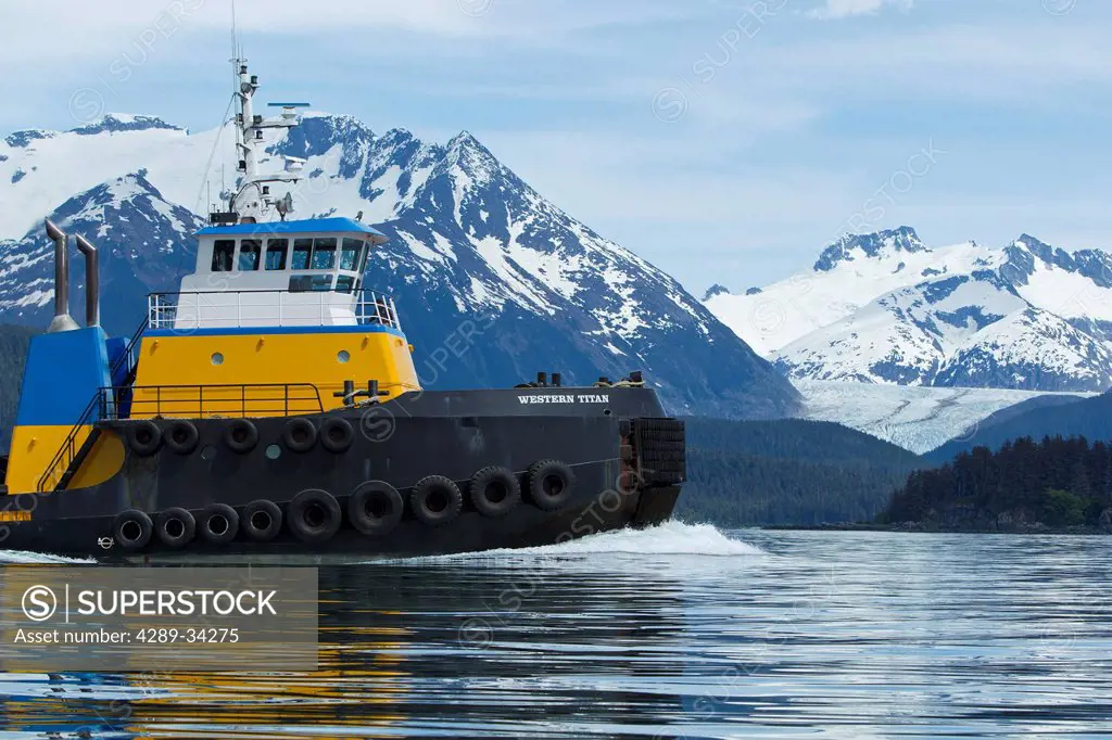 A tug pulling a barge cruises through the Inside Passage on its way south from Skagway, Alaska. Lynn Canal, Alaska Marine Lines.