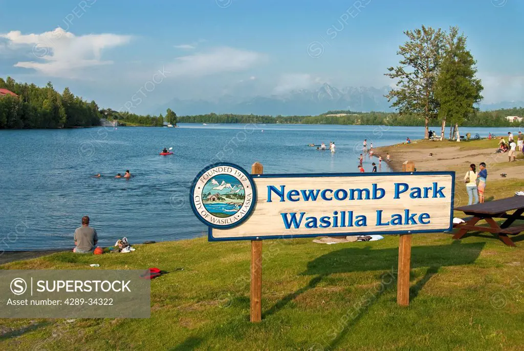 Sunny evening view of people enjoying Newcomb Park and Wasilla Lake, Wasilla, Mat_Su Valley, Southcentral Alaska, Summer