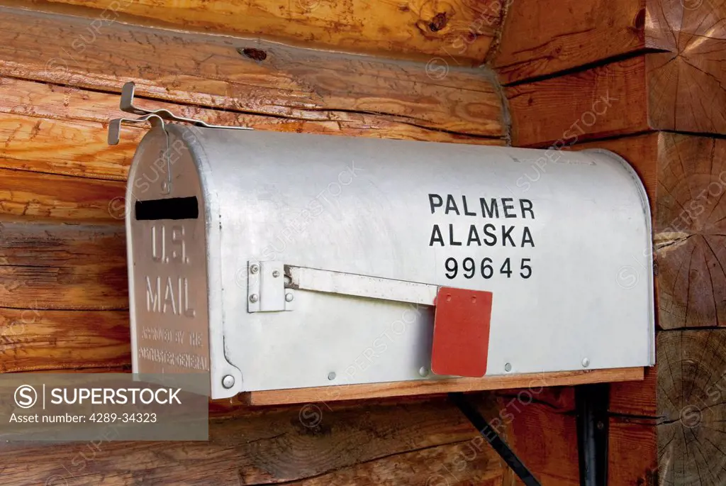 Close up of a rustic mailbox with Palmer, Alaska and zip code on the side, Southcentral Alaska, Summer. Digitally Altered