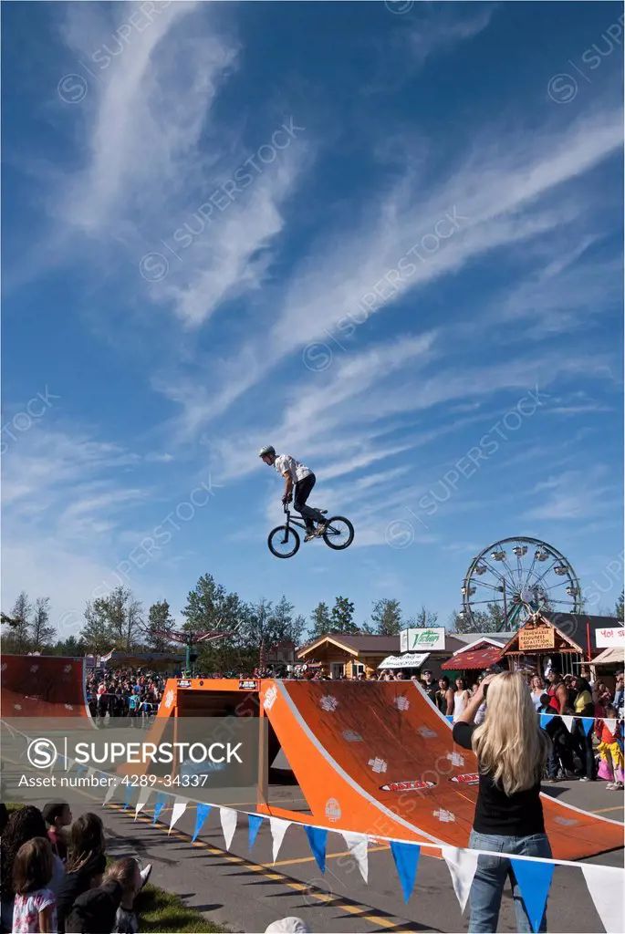 Bicyclist performing a stunt during the King BMX Stunt Show on a sunny day at the Alaska State Fair, Palmer, Southcentral Alaska, Autumn