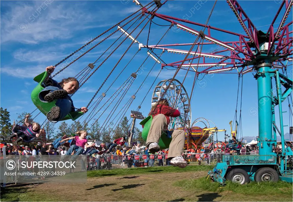 People riding the amusement park swing ride at Alaska State Fair in Palmer, Southcentral Alaska, Autumn