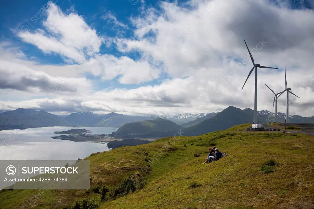Hikers enjoying a sunny afternoon walk near the wind turbines, part of the Pillar Mountain Wind Project, operated and owned by the Kodiak Electric Ass...