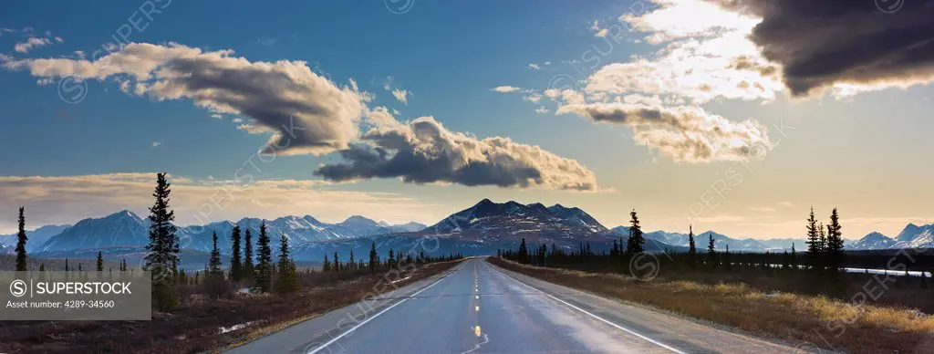 View of the George Parks Highway as it passes through the Alaska Range foothills in Broad Pass with Reindeer Hills in the background, Southcentral Ala...