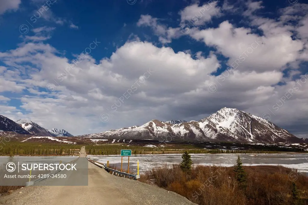 The Denali Highway bridge over the Susitna River with Clearwater Mountains in the background, Southcentral Alaska, Spring
