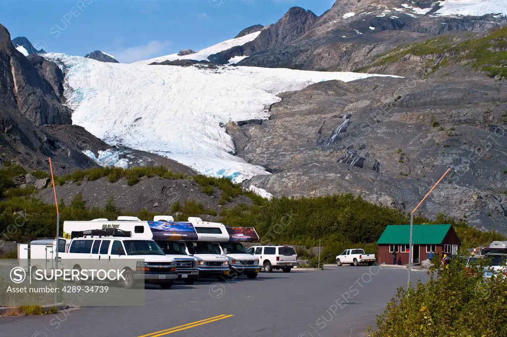 Vehicles parked in the parking lot for the Worthington Glacier State Recreation Area with Worthington Glacier in the background, Southcentral Alaska, ...