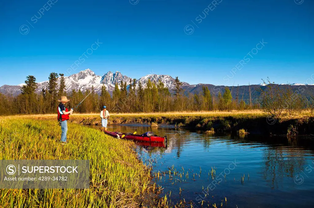 Father and sun kayak to their to Rabbit Slough in the Palmer Haystack Flats wildlife refuge, Matanuska_Susitna Valley, Southcentral Alaska, Spring