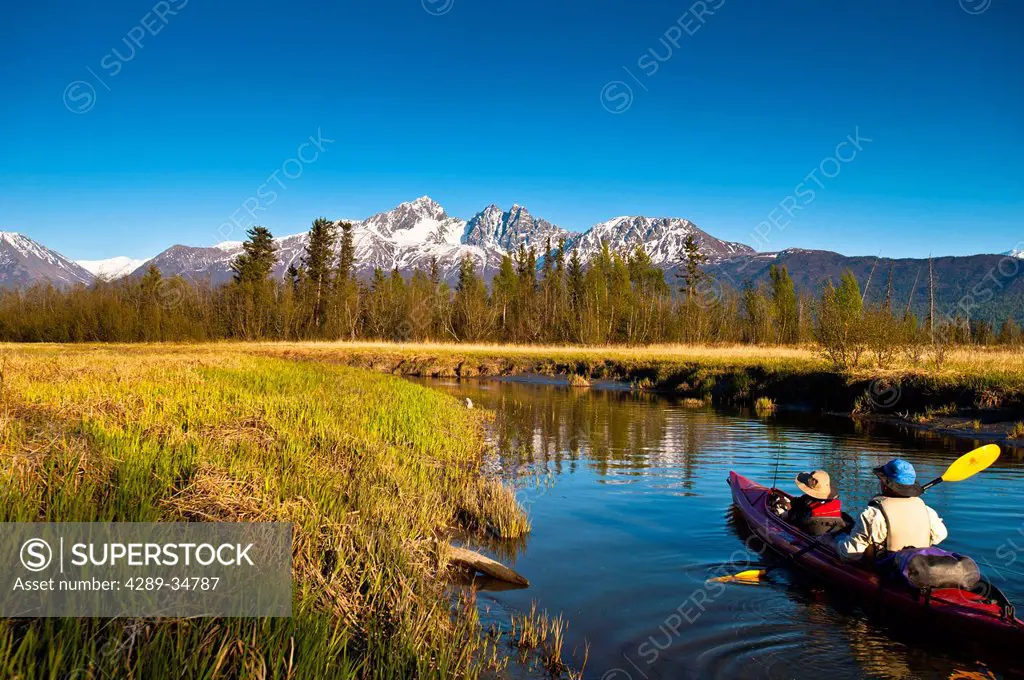 Father and son kayaking on Rabbit Slough in Palmer Haystack Flats Wildlife Refuge on a sunny spring day in the Matanuska_Susitna Valley, Southcentral ...