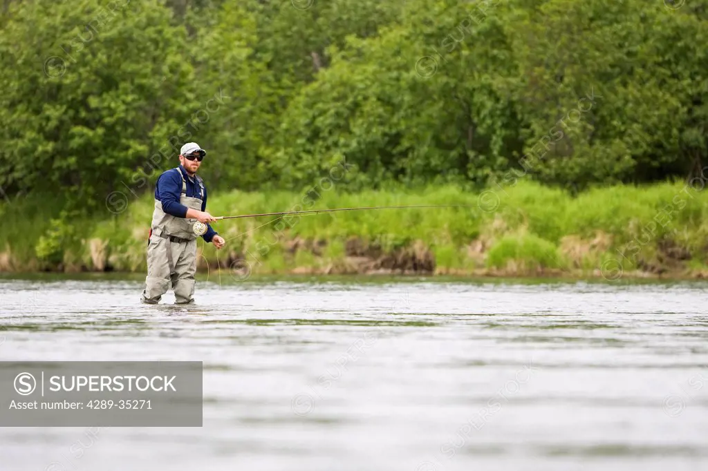 A sportfisherman fishing for salmon on the Mulchatna River in the Bristol Bay region, Southwest Alaska, Summer