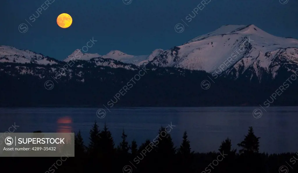 View of a full moon rising over Kachemak Bay near Homer, Kenai Peninsula, Southcentral Alaska, Spring