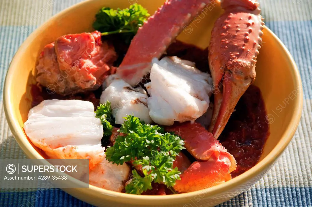 Close up view of Cioppino fish stew containing fresh Alaskan Tanner Crab, Smoked King Salmon, Halibut, and Rockfish, Alaska