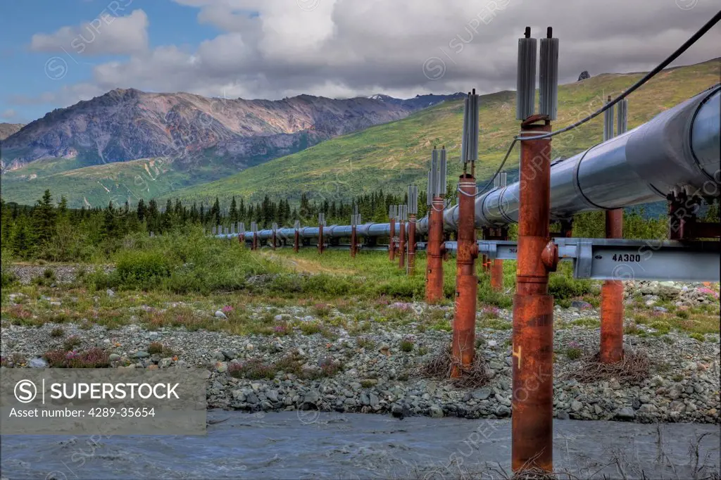 View of the Alyeska Pipeline crossing a river along the Richardson Highway north of Paxson, Southcentral Alaska, Summer, HDR