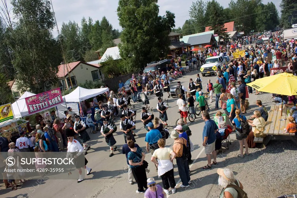 Spectators watch a Scottish band marching to bagpipe music during the Moose Dropping Festival Parade, Talkeetna, Southcentral Alaska, Summer