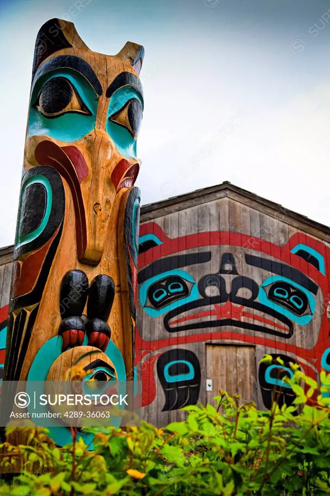 Close up of Raven totem pole and Beaver House at Saxman Totem Park, Ketchikan, Southeast Alaska, Summer