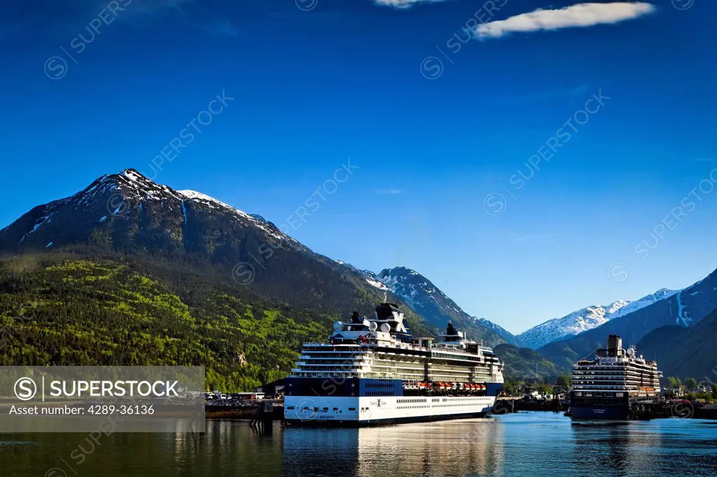 Alaska Marine Highway ferry moored next to a Celebrity Cruises cruise ship at the port of Skagway, Southeast Alaska, Summer