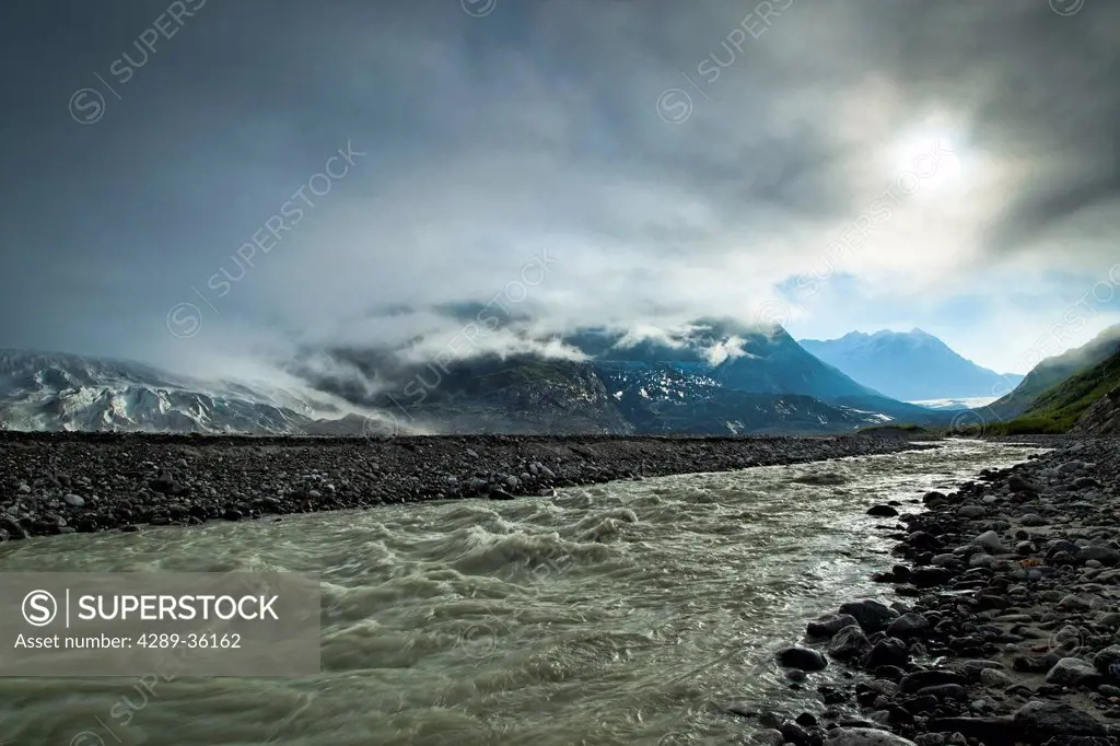 Silt laden meltwater cuts through the moraine of Riggs Glacier, Glacier Bay National Park & Preserve, Southeast Alaska, Summer