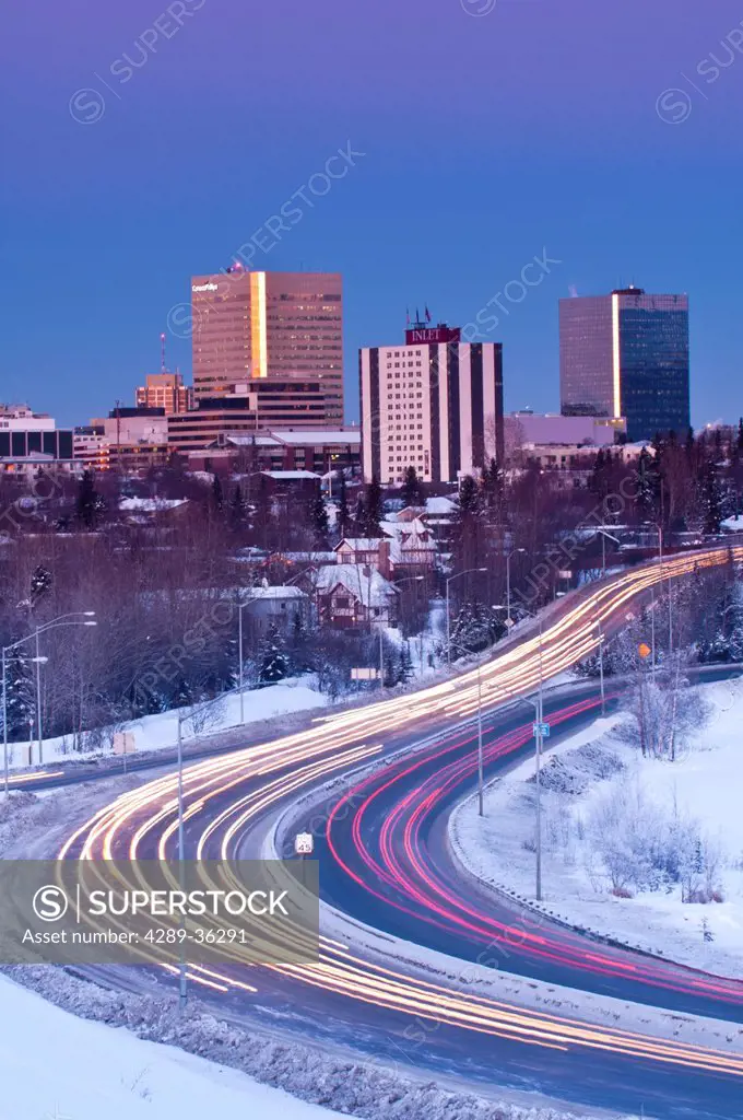 Traffic travels to and from downtown Anchorage during early evening along Minnesota Blvd., Southcentral Alaska, Winter