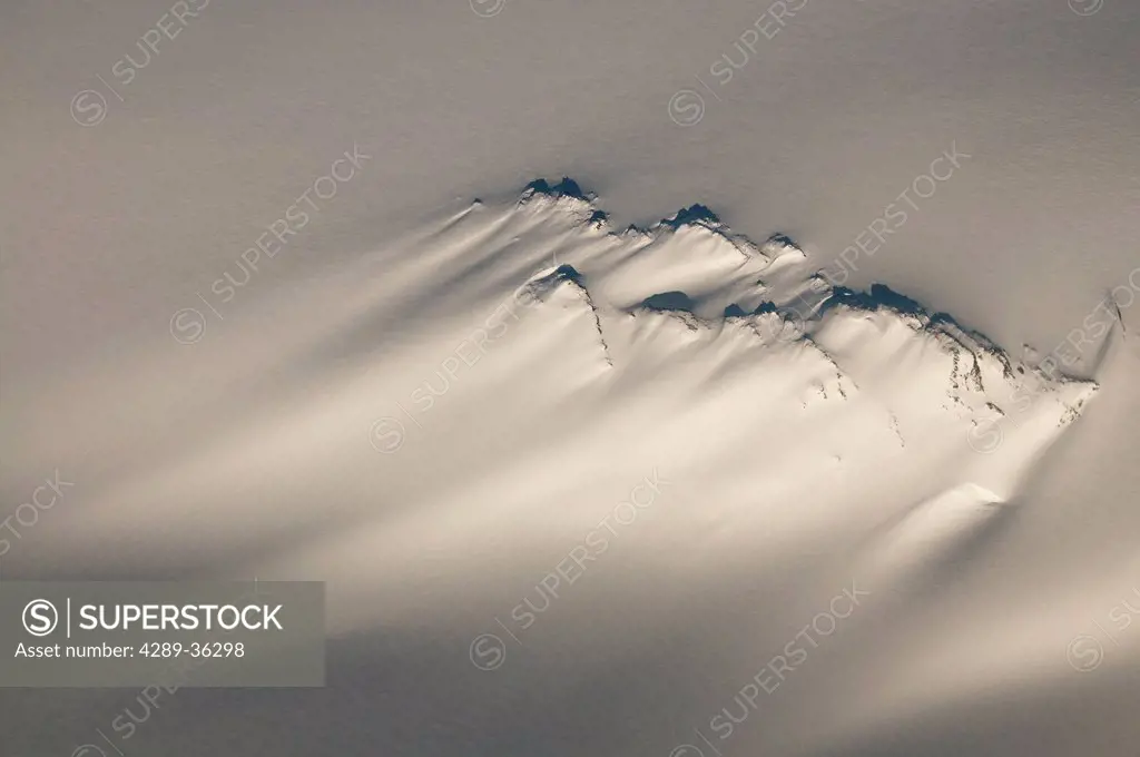 Aerial of a windswept nunatak on the Harding Ice Field in Kenai Fjords National Park, Southcentral Alaska, Winter