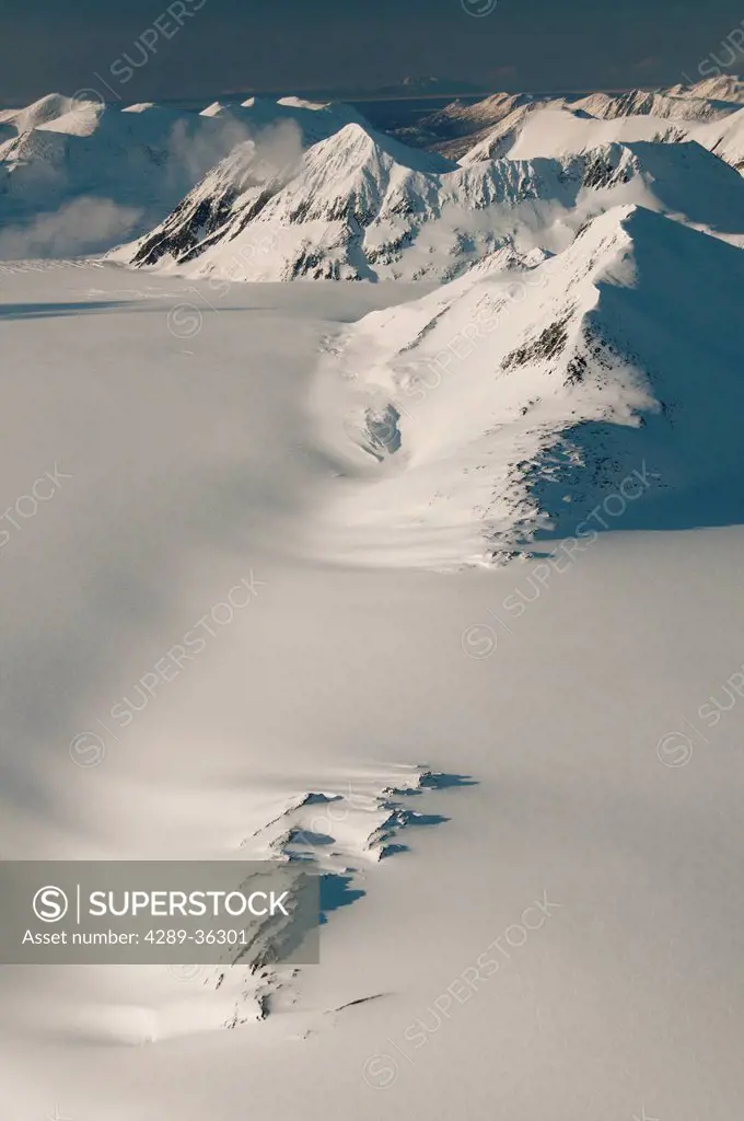 Snow swept mountains and a nunatak on the Harding Ice Field in Kenai Fjords National Park, Southcentral Alaska, Winter
