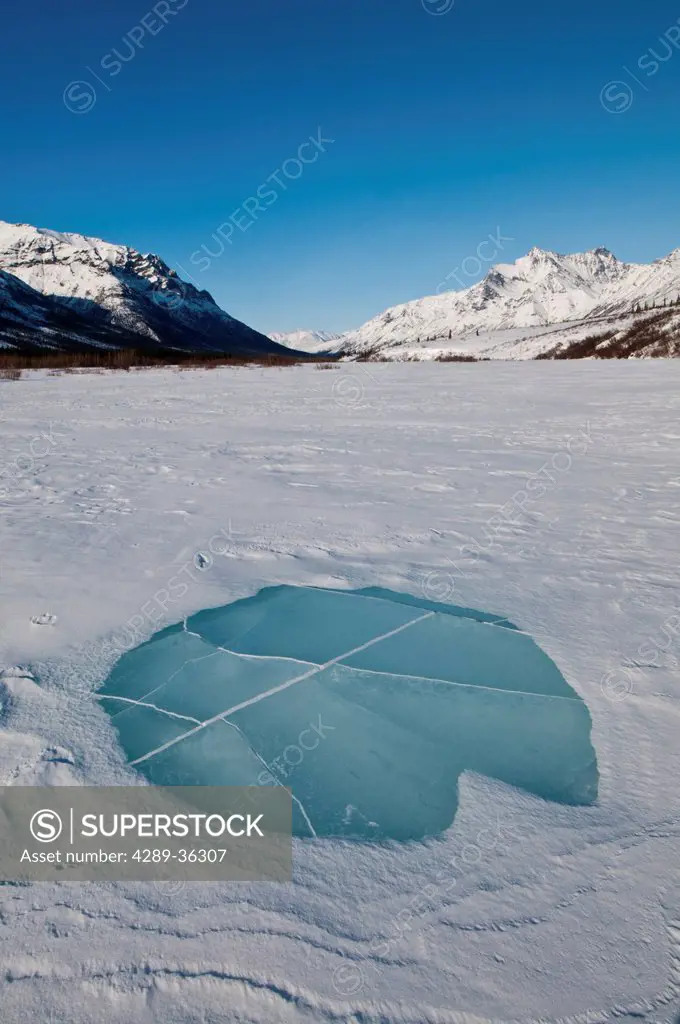 Snowcovered overflow ice on the North Fork of the Koyukuk River with the Brooks Range in the background, Gates of the Arctic National Park & Preserve,...