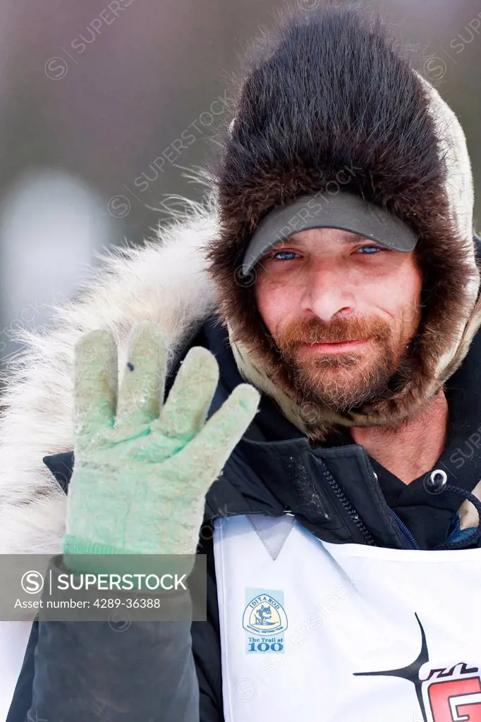 Digitally altered.Lance Mackey raises four fingers on his right hand to predict his fourth win in the 2010 Iditarod during the ceremonial start in Anc...