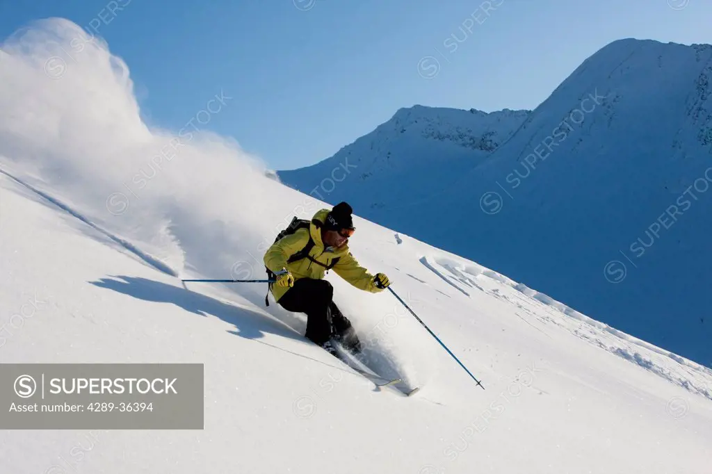 Downhill skier in fresh powder in Chugach Mountains of Turnagain Pass, Southcentral Alaska, Winter