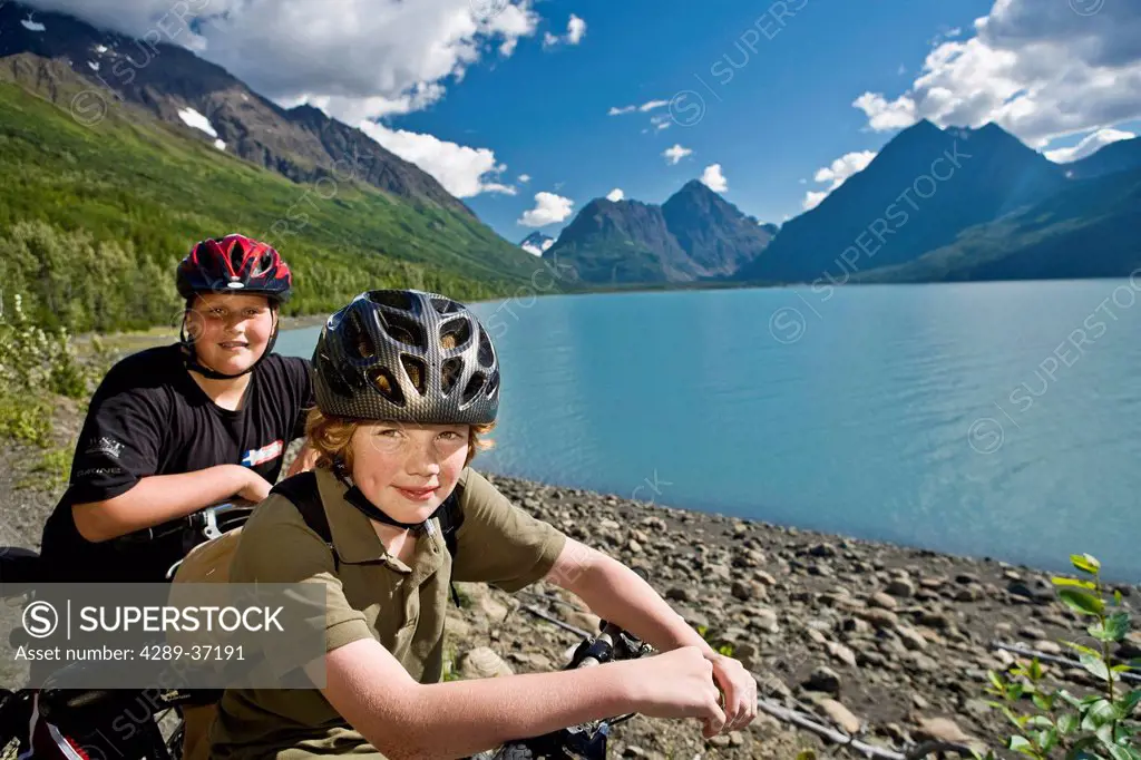 Portrait Of Teenage Boys Taking A Break From Riding Mountain Bikes On The Eklutna Lake Bike Trail During Summer In Southcentral Alaska.