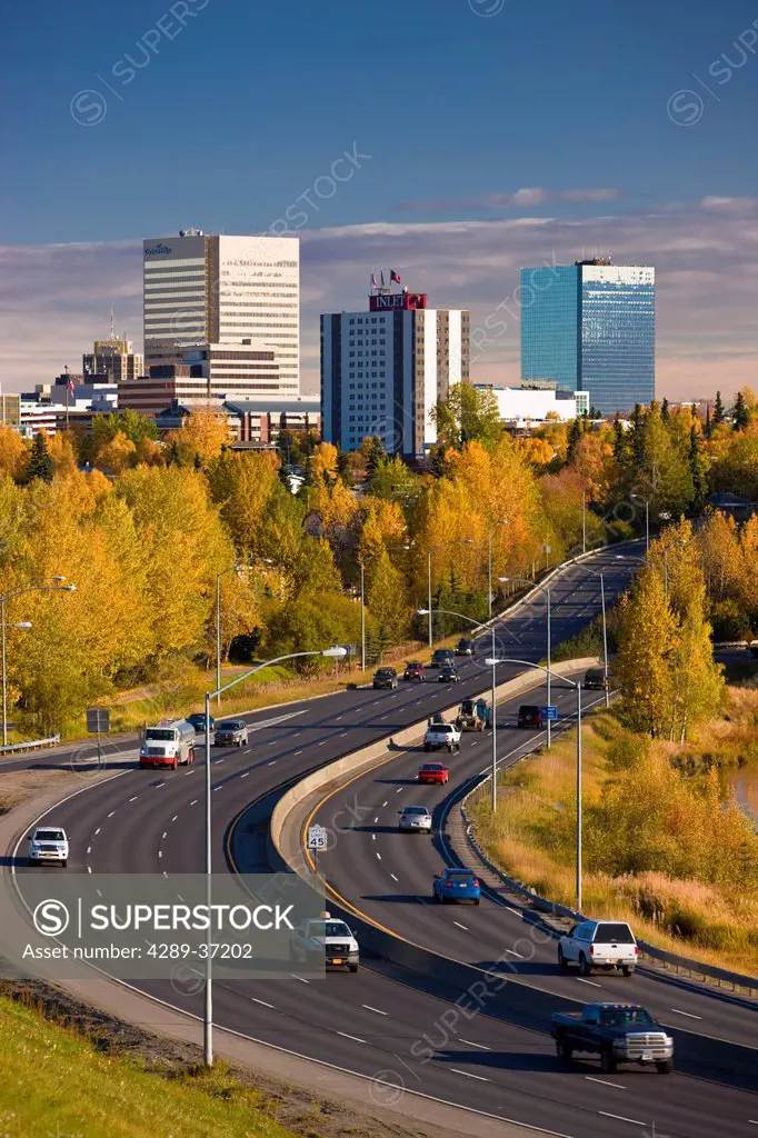 Scenic View Of Minnesota Blvd. Traffic Along Westchester Lagoon On A Sunny Day With Downtown Anchorage In The Distance, Southcentral Alaska, Fall