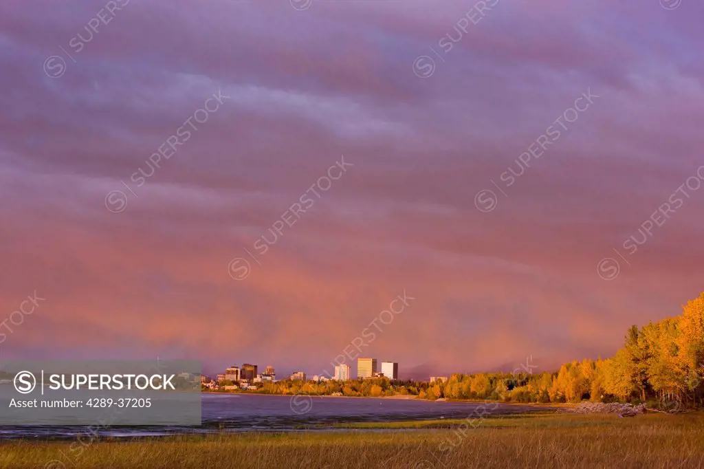Panoramic View Of The Anchorage Skyline At Sunset Taken From The Tony Knowles Coastal Trail During High Tide, Southcentral Alaska