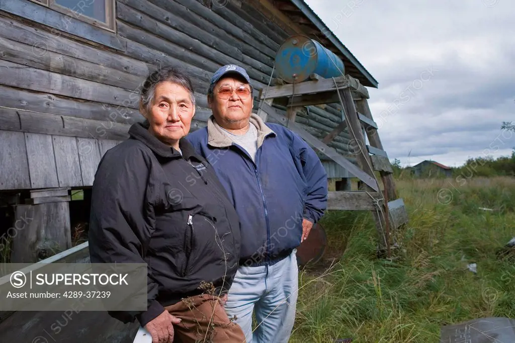 Portrait Of Elder Native Yupik Couple In Front Of Log House Akiachak Western Alaska Autumn Outdoors