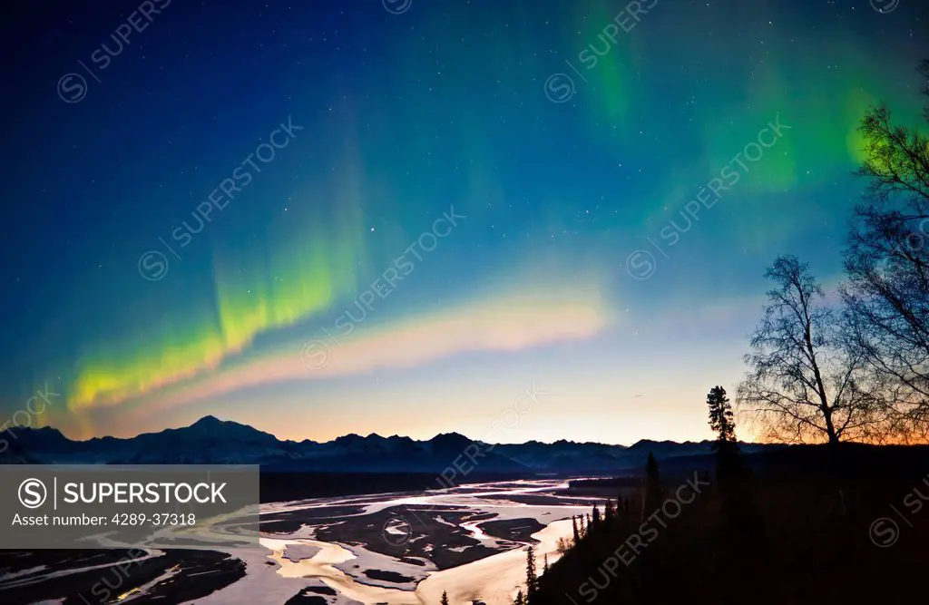 View Of Northern Lights In The Sky Above Southside Mount Mckinley And The Alaska Range At Twilight, Chulitna River In The Foreground, Denali State Par...
