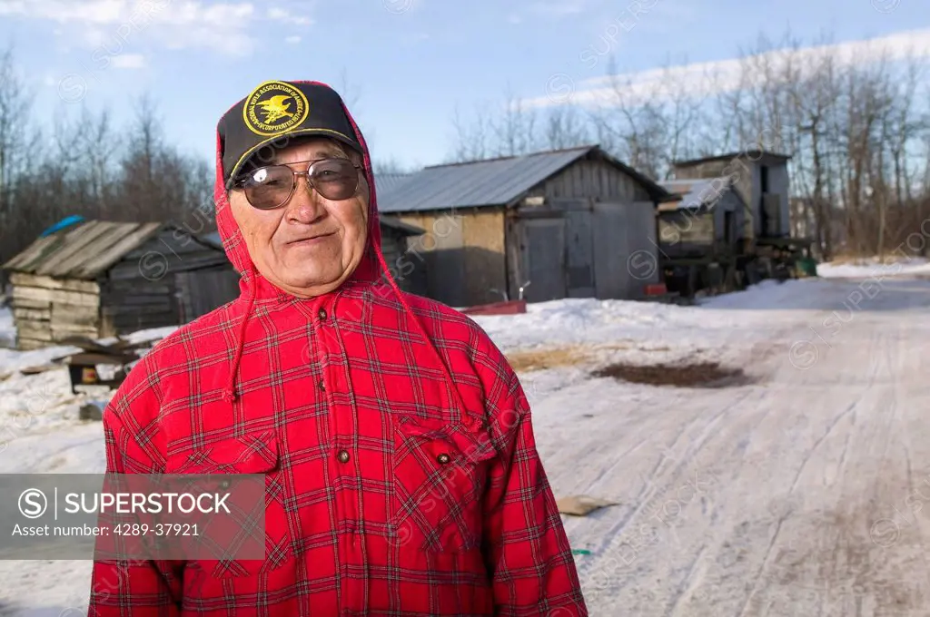 Elder Native Yupik Man Outside Standing In Front Of His Work Sheds Akiak Western Alaska Winter