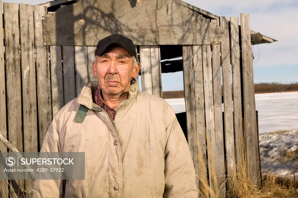 Elder Native Yupik Man Outside Standing In Front Of His Smokehouse Akiak Western Alaska Winter