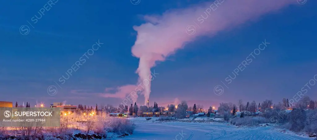 Twilight View Of Downtown Fairbanks And The Frozen Chena River With The Steam Plume From The Powerplant In The Background During Winter In Interior Al...