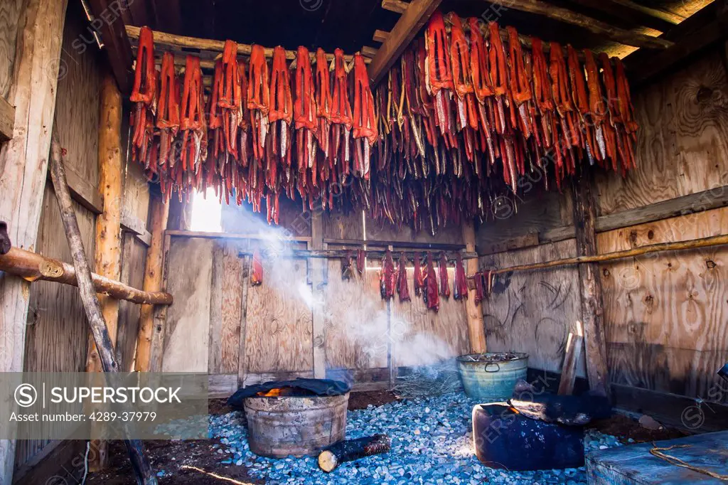 Strips Of Sockeye Salmon Hanging In A Large Smoker For Drying And Smoking As A Shaft Of Light Streams In Showing The Smoke From The Fires; Igiugig Bri...