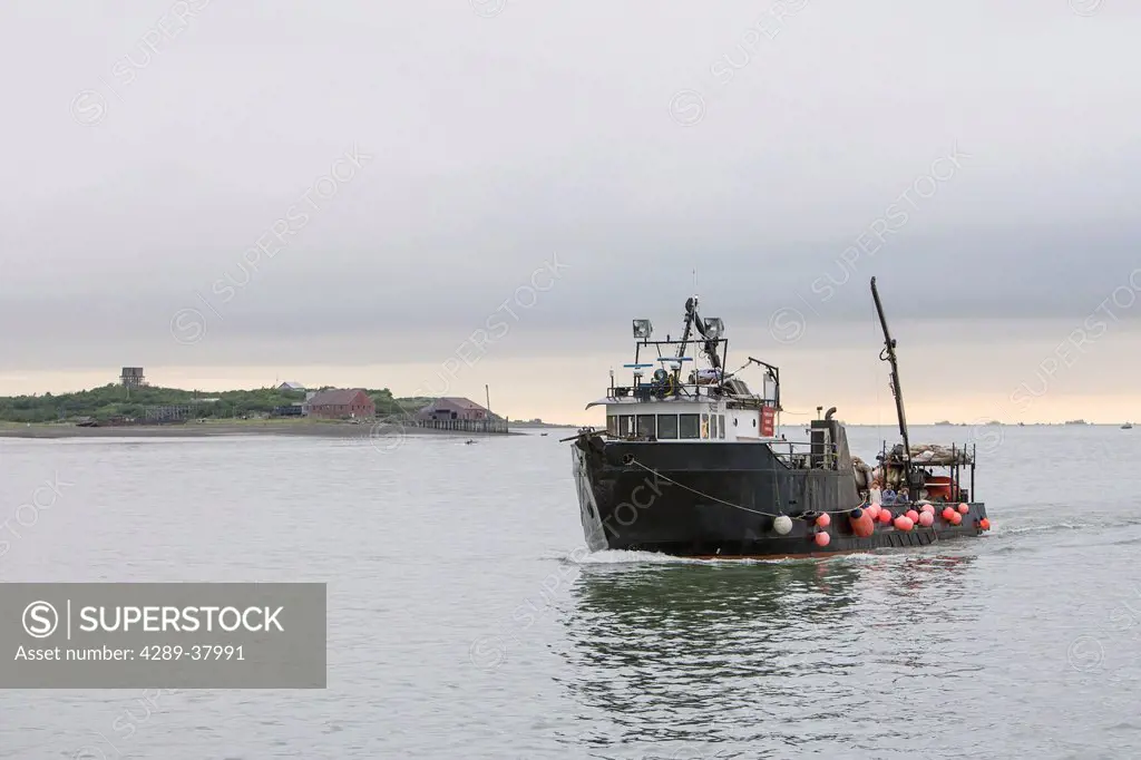 The Nushagak Spirit A Tender Vessel Motors Up The Naknek River With An Old Abandoned Cannery And Dock And The Bristol Bay Skyline In The Background At...