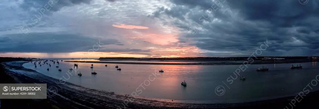 Commercial Salmon Fishing Boats Rest At Anchor In The Naknek River Under A Dramatic Sunset; Bristol Bay Alaska United States Of America