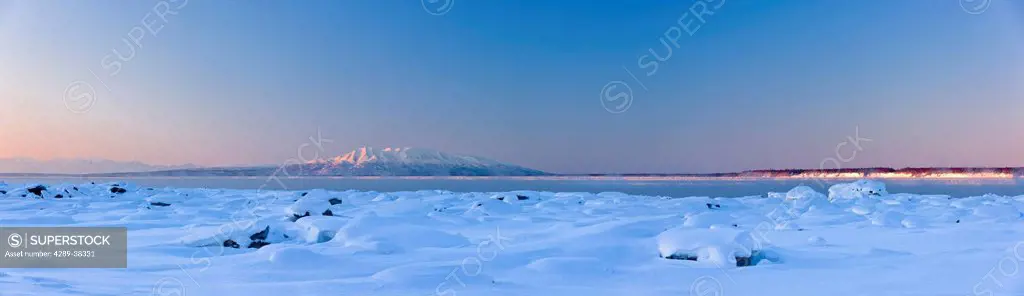 Panorama winter scenic of Mount Susitna and the snow covered tidal flats of Knik Arm at sunset, Tony Knowles Coastal Trail, Anchorage, Southcental Ala...