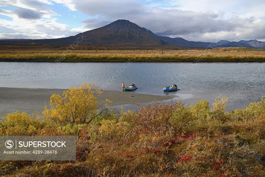 A Man Guards The Rafts Along The Sheenjek River While The Remainder Of His Party Hikes To Kuirzinjik Lake (Lobo Lake) In Arctic National Wildlife Refu...
