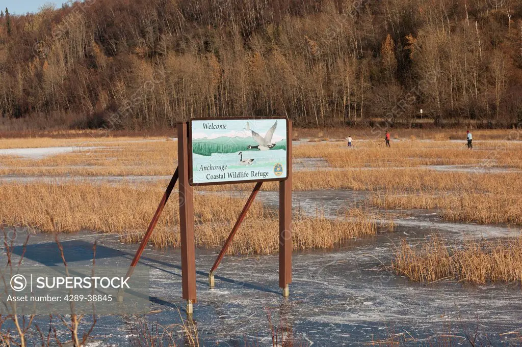 The sign at Potter Marsh's south end with some ice skaters in background, Autumn, Southcentral Alaska south of Anchorage.