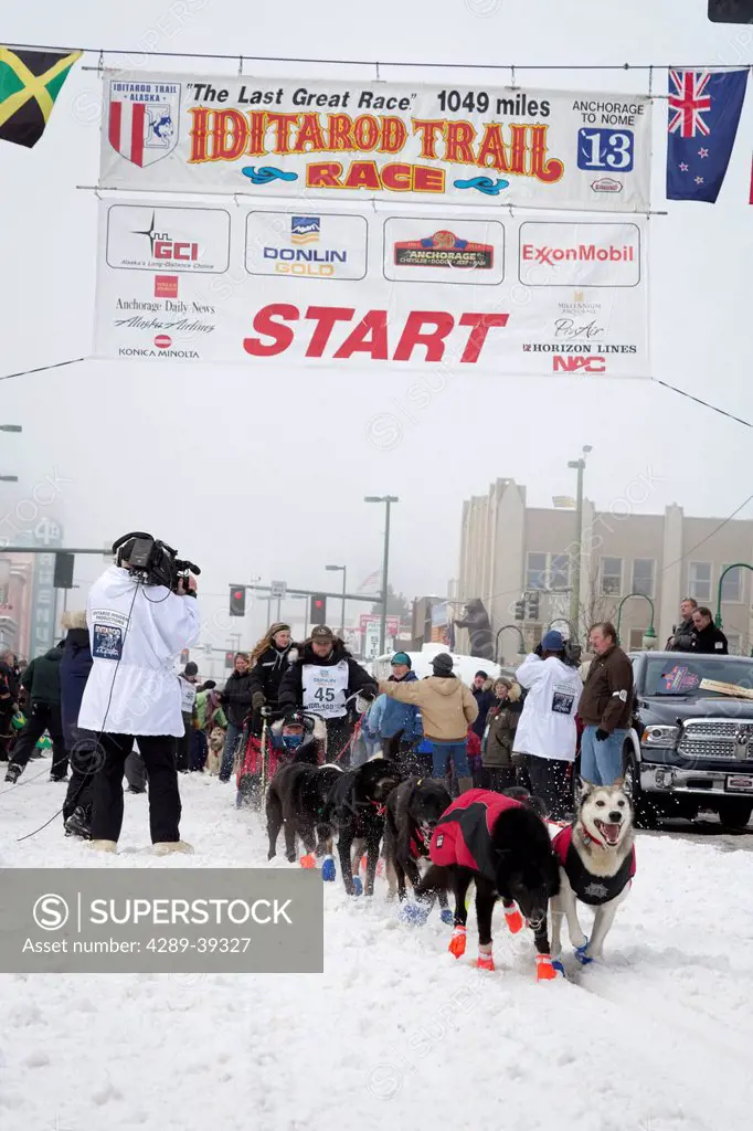 Curt Perano and team leave the ceremonial start line at 4th Avenue and D street in downtown Anchorage during the 2013 Iditarod race.