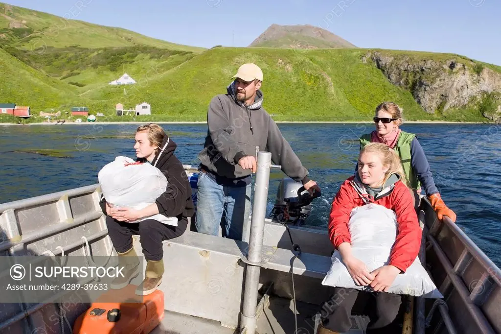 The Laukitis family taking a skiff ride from their home and fish camp across False Pass towards Unimak Island.