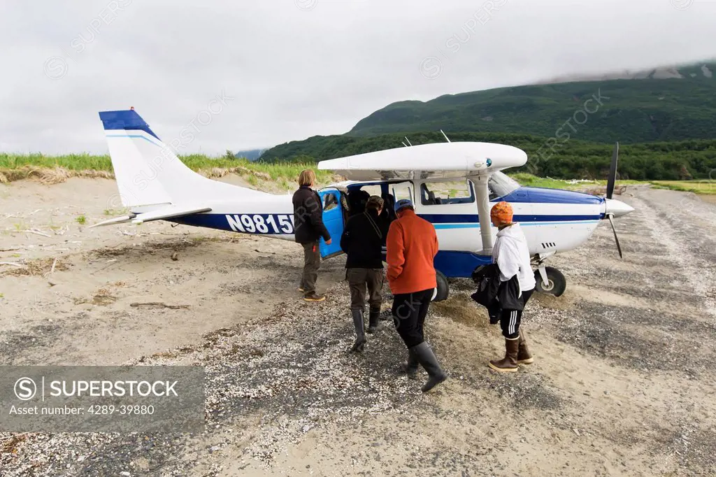 Visitors boarding Cessna in Hallo Bay, Katmai National Park, Alaska Peninsula, Southwest Alaska, summer.