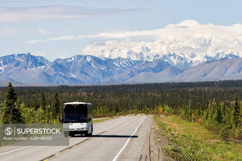Tour bus on George Parks Highway with Mt. McKinley in background, Interior Alaska, summer.