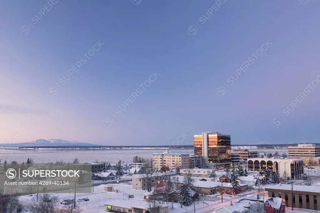 Elevated view of downtown Anchorage Skyline, Knik arm and Mount Susitna in the background, just past sunset, winter, Anchorage, Southcentral Alaska, U...
