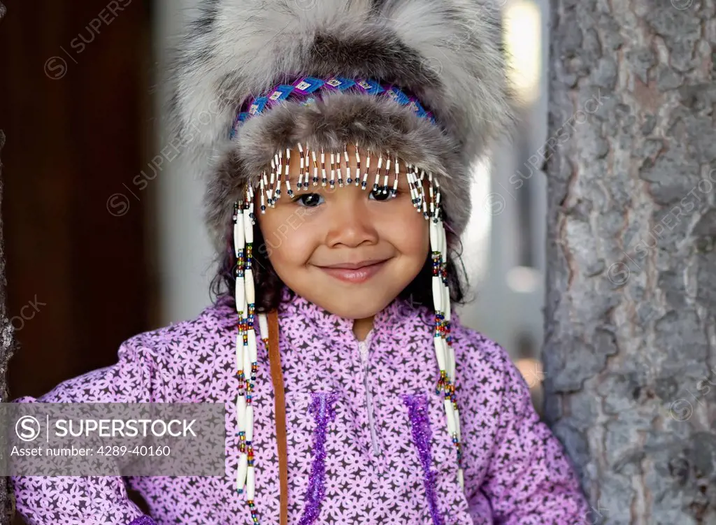 Eskimo girl wearing an Alaskan Native headdress and kuspuk in Eagle River, Southcentral Alaska in Summer.