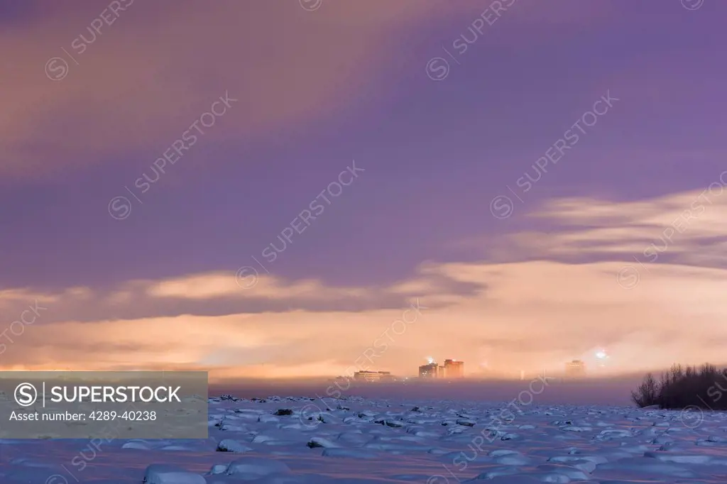 Scenic view of Downtown Anchorage through fog at sunrise, Southcentral Alaska, Winter