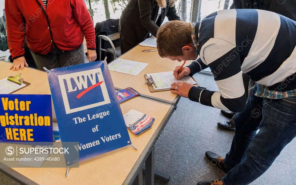 Newly Naturalized Citizen Registering To Vote At A League Of Women Voters Booth. He Just Became A Naturalized Citizen In A Ceremony Held At The Bp Ene...
