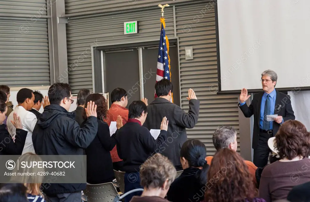 Terry Charbonnequ Of The U.S. Citizenship And Immigration Services Leads The Swearing-In Process Of Becoming An American Citizen As Part Of The Natura...